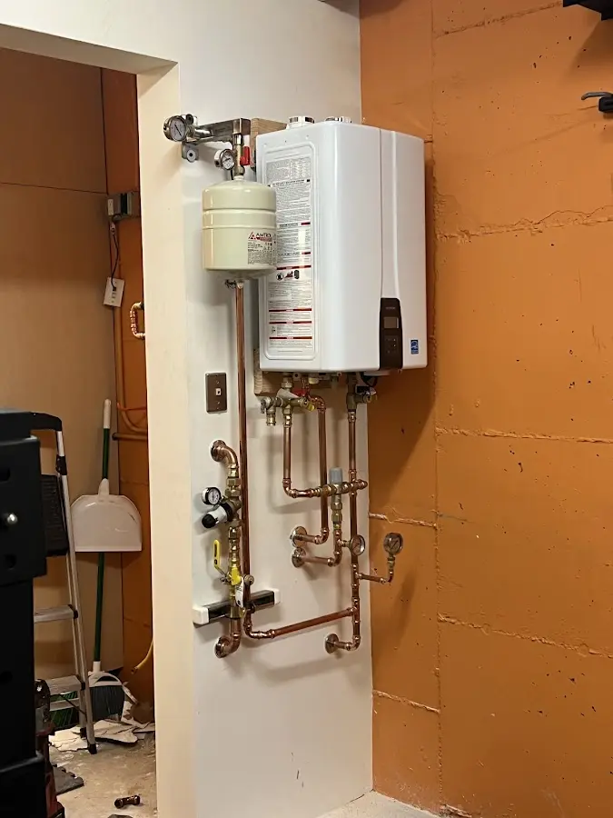 Plumbing technician inspecting water heater connections in Lockhart